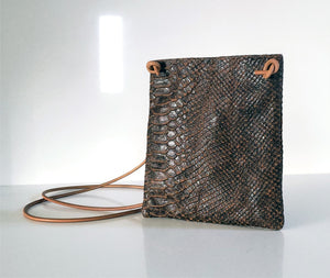 The brown python purse is crafted in rich Italian leather with an adjustable & detachable shoulder strap to carry it crossbody or as an evening clutch. 