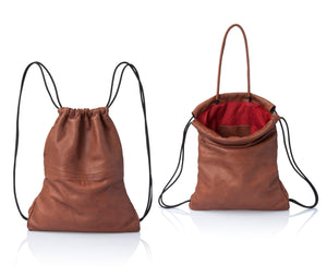 Multi-way leather drawstring backpack crafted with soft Italian Napa leather, adjustable back straps, and leather-covered inner top handles. This style is versatile and can be carried as a backpack, tote, or on the shoulder. Its ideal minimalist design is suitable for long active days & use. Suitable for laptops up to 15inc