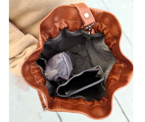 This bucket bag is a must-have for any fashion-savvy individual, crafted in premium soft Italian Napa leather with an adjustable & detachable matching leather strap. Featuring a drawstring tie closure and woven lining. This style is versatile and can be carried as a shoulder or crossbody bag with strap or as a wristlet clutch by the drawstring.