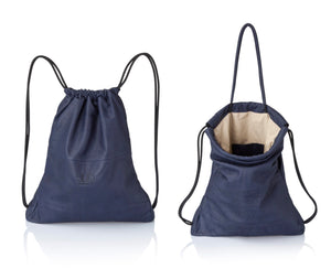 Navy blue multi-way leather drawstring backpack crafted with soft Italian Napa leather, adjustable back straps, and leather-covered inner top handles. This style is versatile and can be carried as a backpack, tote, or on the shoulder. Its ideal minimalist design is suitable for long active days & use. Suitable for laptops up to 15inch.