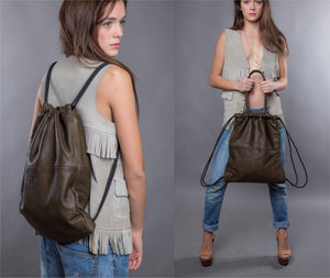 Multi-way leather drawstring backpack crafted with soft Italian Napa leather, adjustable back straps, and leather-covered inner top handles. This style is versatile and can be carried as a backpack, tote, or on the shoulder. Its ideal minimalist design is suitable for long active days & use. Suitable for laptops up to 15inc