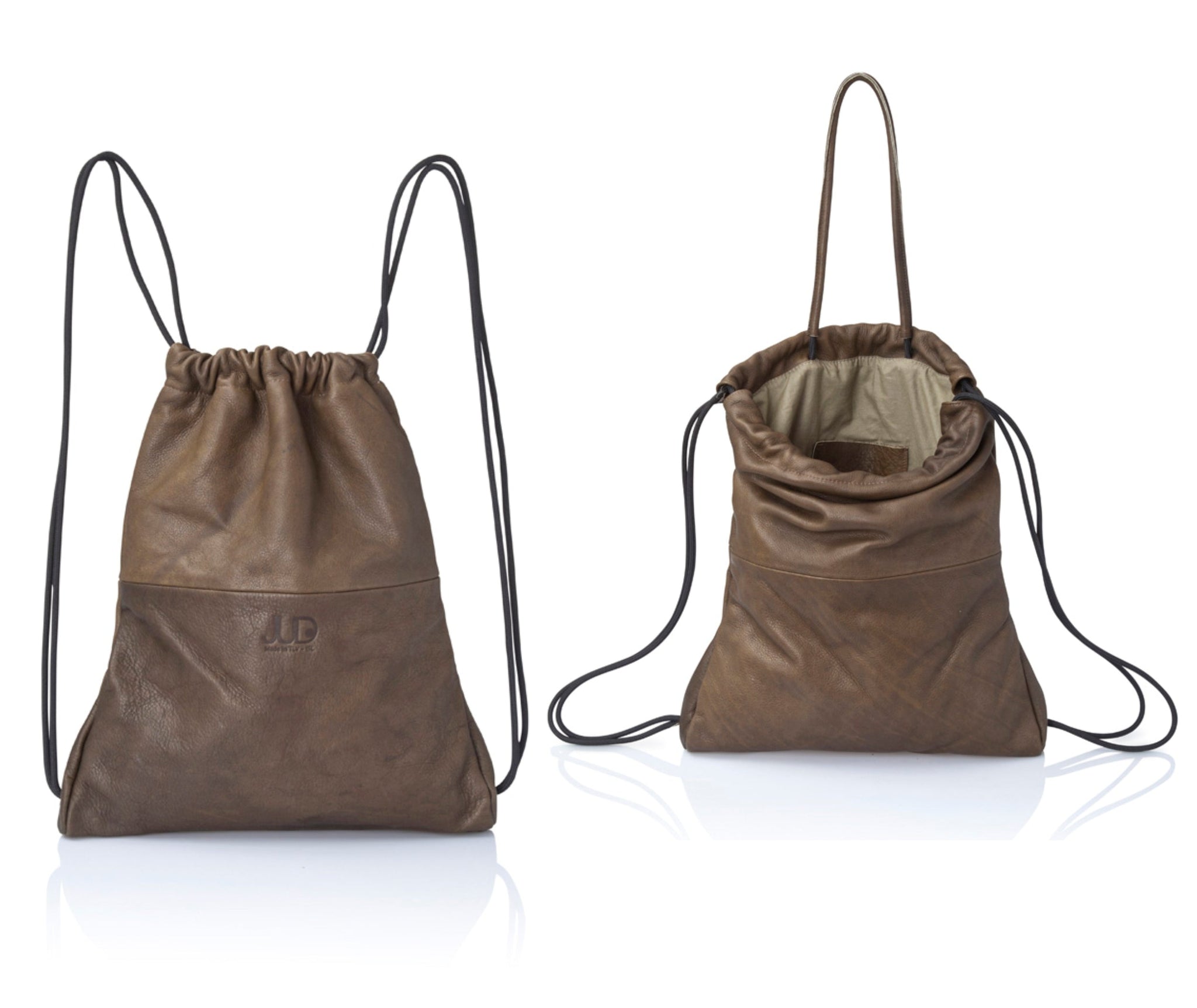 Multi-way leather drawstring backpack crafted with soft Italian Napa leather, adjustable back straps, and leather-covered inner top handles. This style is versatile and can be carried as a backpack, tote, or on the shoulder. Its ideal minimalist design is suitable for long active days & use. Suitable for laptops up to 15inc