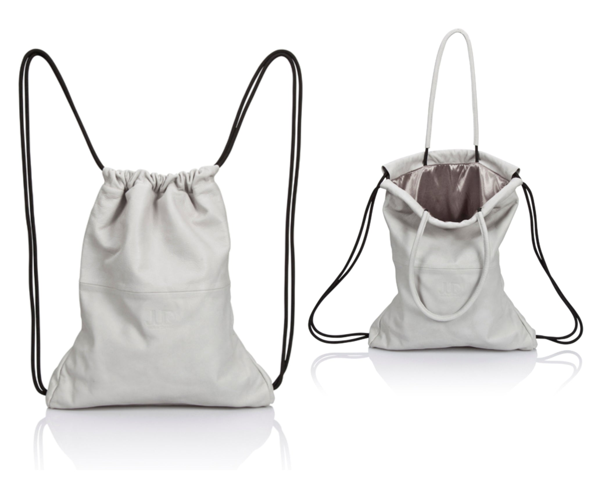 White multi-way leather drawstring backpack crafted with soft Italian Napa leather, adjustable back straps, and leather-covered inner top handles. This style is versatile and can be carried as a backpack, tote, or on the shoulder. Its ideal minimalist design is suitable for long active days & use. Suitable for laptops up to 15inch.